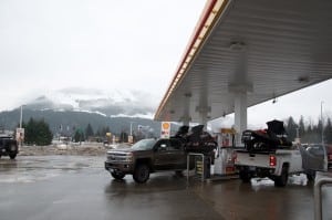 Overcast weather continued to be an issue on Wednesday, Dec. 9. Here, snowmobilers fuel up at the Revelstoke Shell station with Boulder Mountain pictured in the background, its alpine areas obscured by low clouds. Photo: Aaron Orlando/Revelstoke Mountaineer