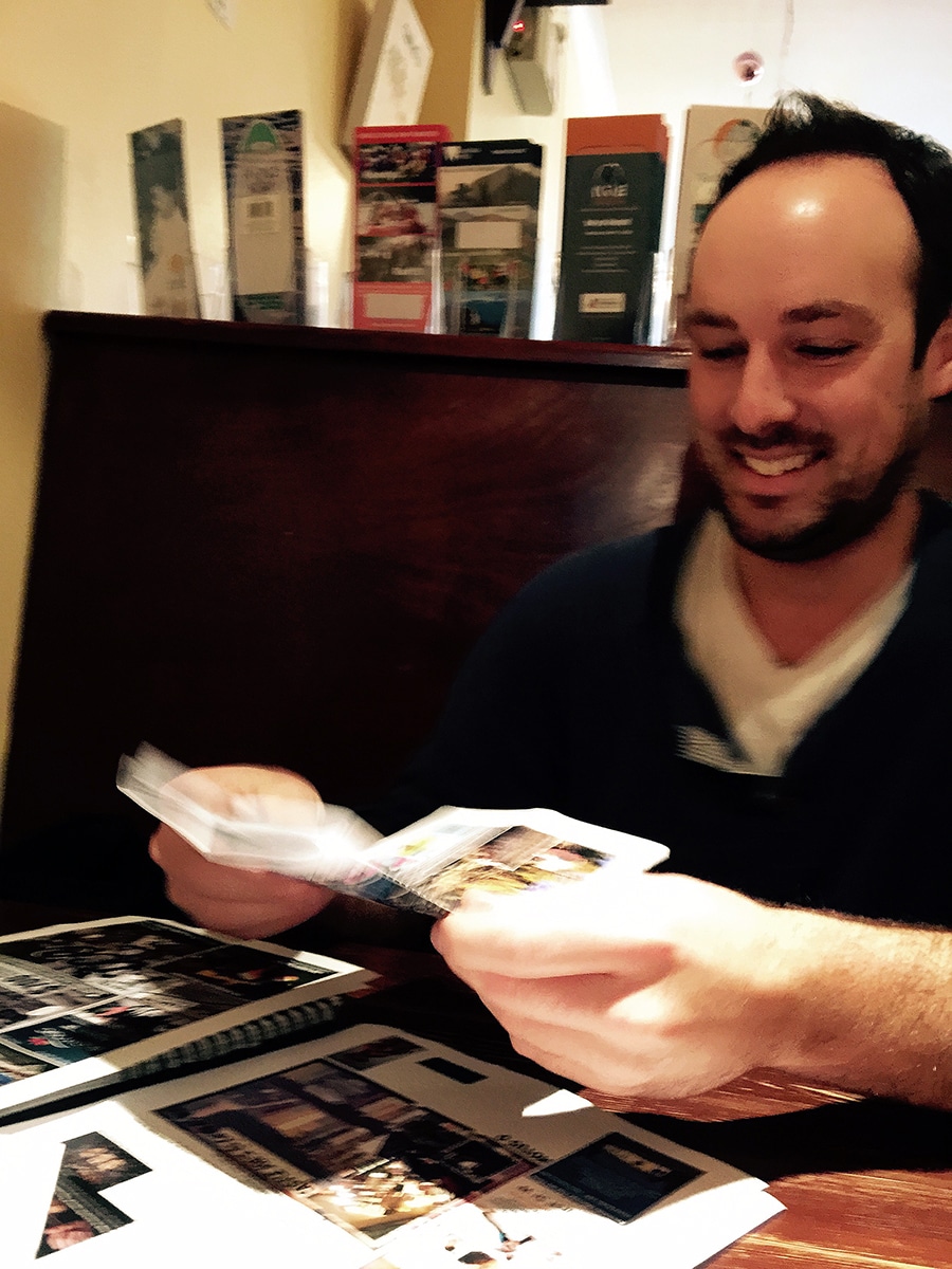 Worden shows me how the fold-up newspaper works, and takes delight in doing it. Photo: Aaron Orlando/Revelstoke Mountaineer